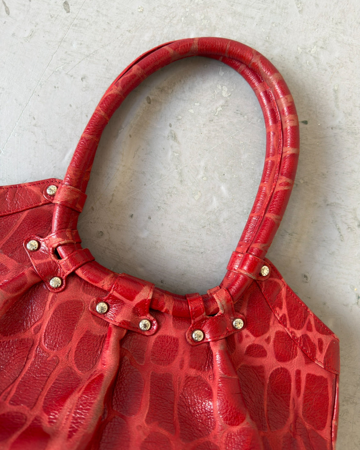 Red crocodile stud bag
